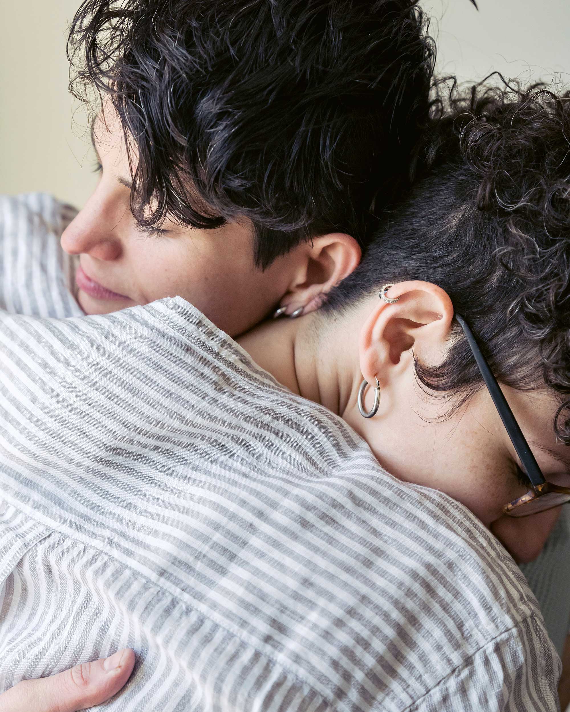 Two people sharing a close, tender embrace, heads resting together in a quiet moment of connection